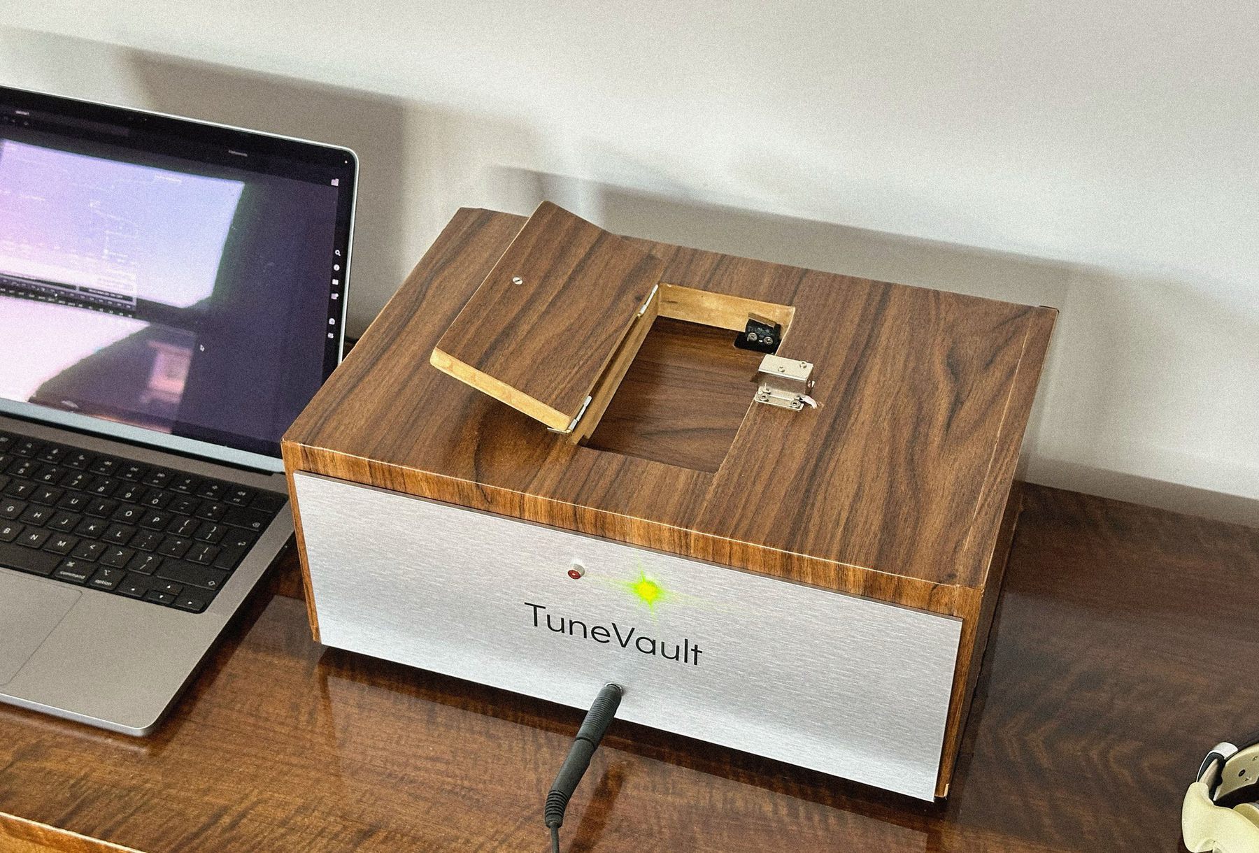 The TuneVault prototype: a wooden box with a brushed aluminium front and an open hatch on top