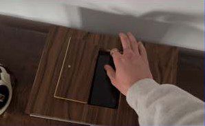 A hand taking the phone out of the unlocked hatch