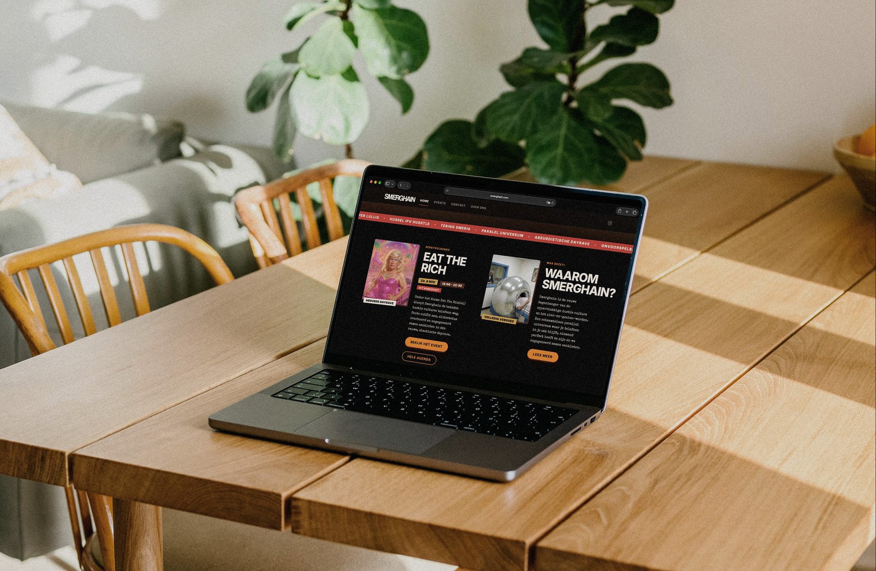 Smerghain website shown on a laptop on a wooden table