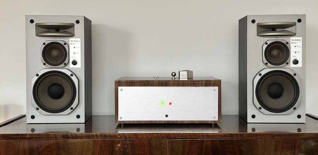 First mockup of TuneVault between two speakers, with a lock and green and red LED indicators